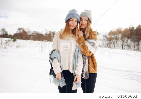 Two cute girls in a winter park Two cute girls in a winter park 61600693