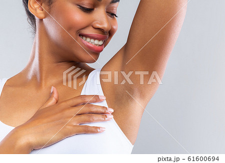 Close up of happy afro girl smelling her armpit 61600694