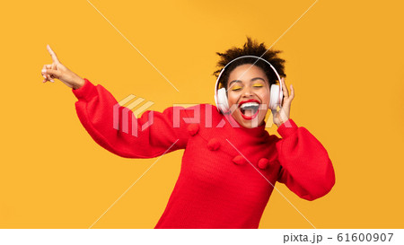 Portrait of happy afro woman enjoying music 61600907