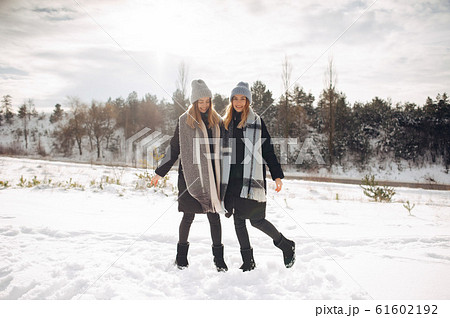 Two cute girls in a winter park Two cute girls in a winter park 61602192