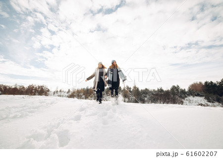 Two cute girls in a winter park Two cute girls in a winter park 61602207