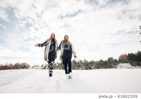 Two cute girls in a winter park 61602209