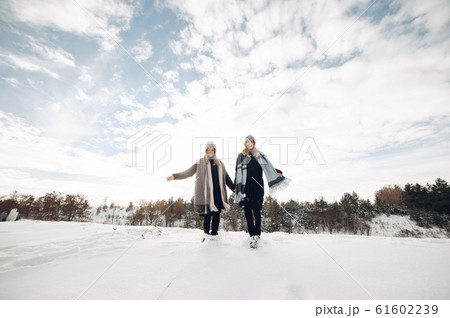 Two cute girls in a winter park 61602239