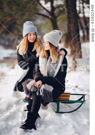 Two cute girls in a winter park Two cute girls in a winter park 61602446