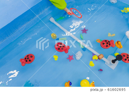 fishing in the paddling pool. Children's toys - Stock Photo