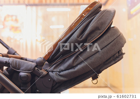 The child sleeps in the stroller. Baby carriage stands on the bank of a frozen. The child sleeps in the stroller. Baby carriage stands on the bank of a frozen. 61602731