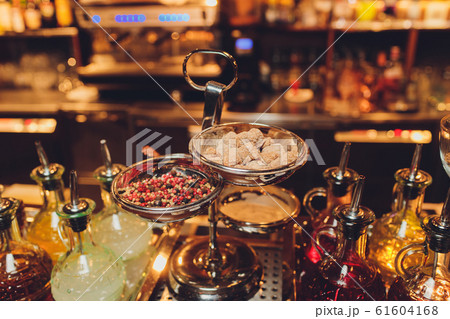 Thai sweet dessert and fruit bar with variety of raw, ingredients, syrup and ice, including pomegranate seeds, Lot Chong, basket of palm sugar pudding, 61604168