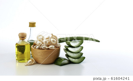 Hair treatment capsule in wooden bowl on white Hair treatment capsule in wooden bowl on white 61604241