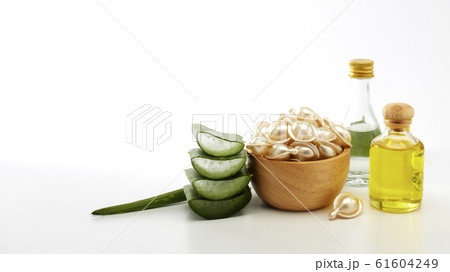 Hair treatment capsule in wooden bowl on white 61604249