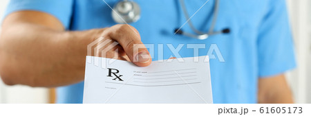 Male medicine doctor in blue uniform hold and give prescription 61605173