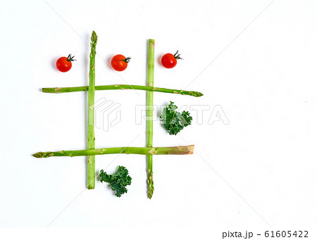 tic tac toe with food, asparagus kale, tomato, top view 61605422