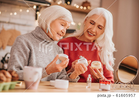 Two good-looking elderly women discussing new creams Two good-looking elderly women discussing new creams 61605957