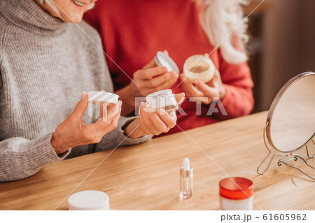 Two good-looking elderly women holding new creams 61605962