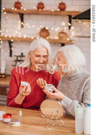 Two good-looking elderly women enjoying skin treatment Two good-looking elderly women enjoying skin treatment 61605992