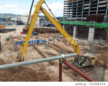 Excavators machine is heavy construction machine used excavate soil at the construction. Powered by long hydraulic arm with bucket. Operate by workers. Excavators machine is heavy construction machine used excavate soil at the construction. Powered by long hydraulic arm with bucket. Operate by workers. 61606144