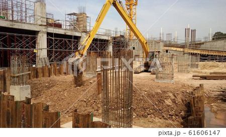 Excavators machine is heavy construction machine used excavate soil at the construction. Powered by long hydraulic arm with bucket. Operate by workers.  61606147