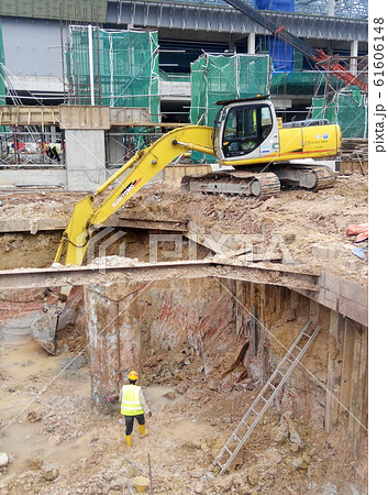 Excavators machine is heavy construction machine used excavate soil at the construction. Powered by long hydraulic arm with bucket. Operate by workers.  61606148