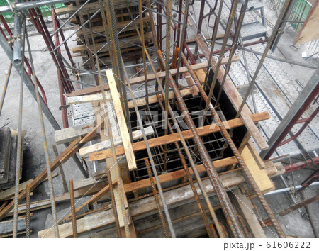 Concrete column steel reinforcement bar at the construction site fabricated by workers.It will be closed by timber form work before concreting work start. 61606222