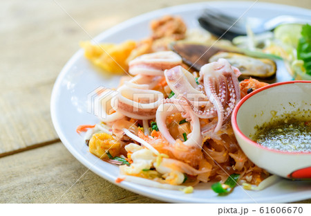 Squid on stir-fried rice noodles (Pad Thai) with Squid on stir-fried rice noodles (Pad Thai) with 61606670