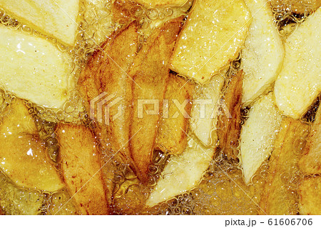 Cooking French fries. Close-up of frying French fries in a deep fryer in hot boiling oil Cooking French fries. Close-up of frying French fries in a deep fryer in hot boiling oil 61606706