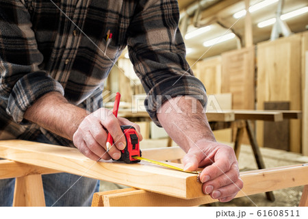 Carpenter at work on wooden boards. Carpentry. Carpenter at work on wooden boards. Carpentry. 61608511