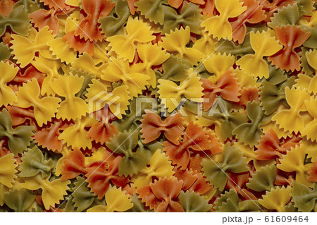 Colored italian pasta butterflies. Creative food background. 61609464