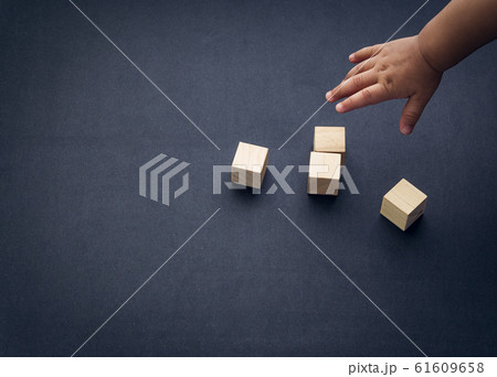 Wooden cube alphabet closeup and children hands Wooden cube alphabet closeup and children hands 61609658