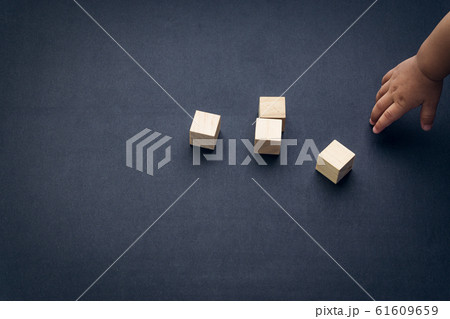 Wooden cube alphabet closeup and children hands Wooden cube alphabet closeup and children hands 61609659
