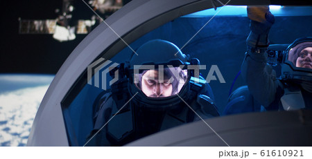 Astronaut looking out of spaceship window Astronaut looking out of spaceship window 61610921