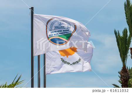 The flag of Agia Napa municipality and the flag of Cyprus. Flags on the flagpole and the stereet lamp post. The wind inflates the flag. The flag of Agia Napa municipality and the flag of Cyprus. Flags on the flagpole and the stereet lamp post. The wind inflates the flag. 61611032