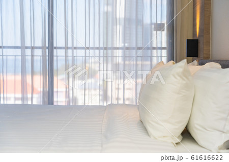 White comfortable pillow on bed decoration interior White comfortable pillow on bed decoration interior 61616622