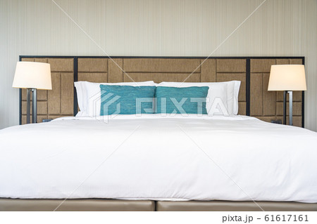 White comfortable pillow on bed decoration interior White comfortable pillow on bed decoration interior 61617161