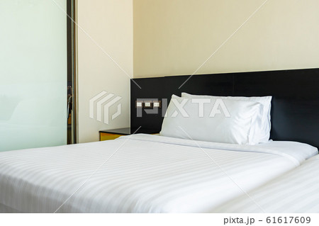 Pillow and blanket on bed with light lamp decoration interior 61617609