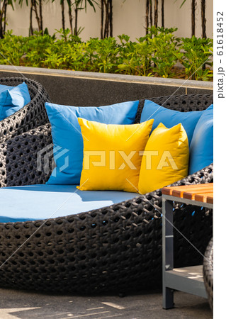 Outdoor patio in the garden with sofa chair and pillow decoration Outdoor patio in the garden with sofa chair and pillow decoration 61618452