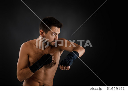 boxer man shows the different movements on black background 61629141