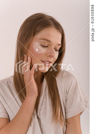 Portrait of a young woman with with a eyepatch on her face. 61630898