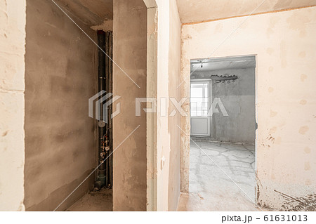 Empty interior for design, gray concrete wall. Empty room. Space for text and picture. Concrete walls, slabs, interior of a new residential building. Partitions in a new apartment. 61631013