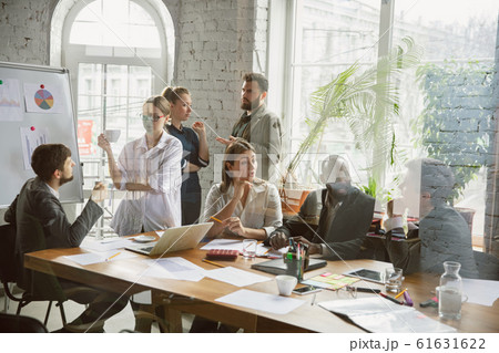 Group of young business professionals having a meeting, creative office Group of young business professionals having a meeting, creative office 61631622