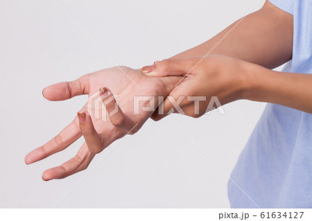woman suffering from trigger finger, cps, wrist woman suffering from trigger finger, cps, wrist 61634127