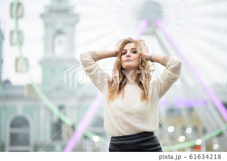 Gorgeus blonde woman in leather skirt posing on 61634218