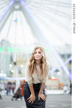 Gorgeus blonde woman in leather skirt posing on 61634220