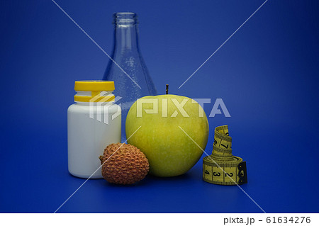 Still life with measuring tape and fruits Still life with measuring tape and fruits 61634276