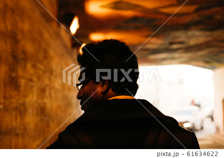 Portrait of a man in the backlight looking back in a tunnel 61634622