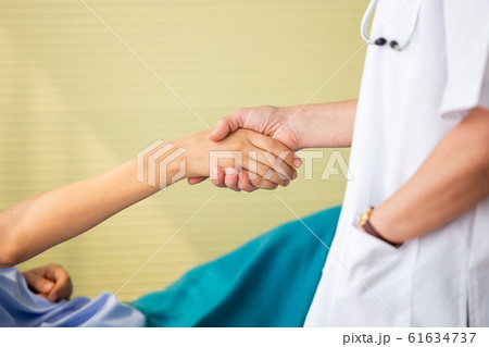 Doctor holding hand treat patients in hospital, Doctor holding hand treat patients in hospital, 61634737