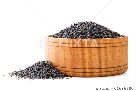 Poppy in a wooden plate close-up on a white 61636280