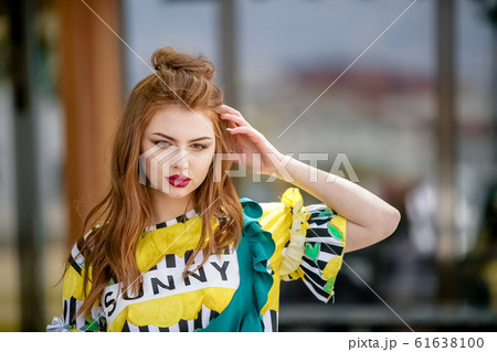 Bright photo of a woman during a vacation on a walk through the city's warm landscapes 61638100
