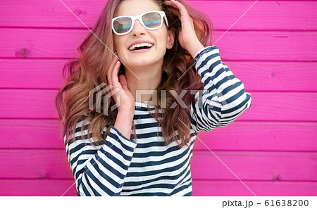 Bright portrait. Pointing copy space. studio Photo of attractive young woman. 61638200