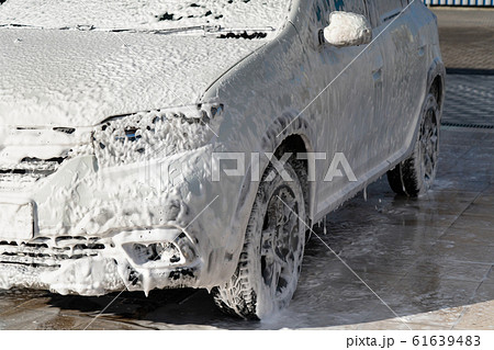 Self service high pressure car wash. Vehicle covered with foam Self service high pressure car wash. Vehicle covered with foam 61639483