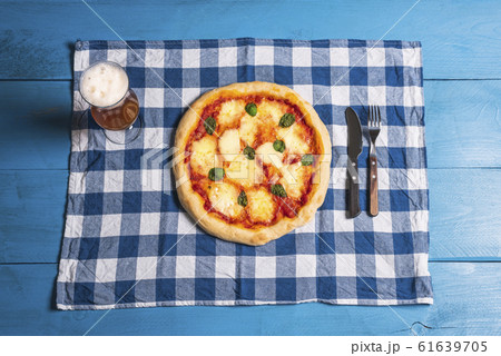 Mozzarella pizza, basil and beer on blue table. Mozzarella pizza, basil and beer on blue table. 61639705