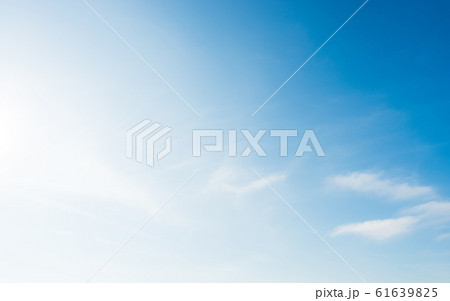 Bright and soft blue sky with small white clouds 61639825